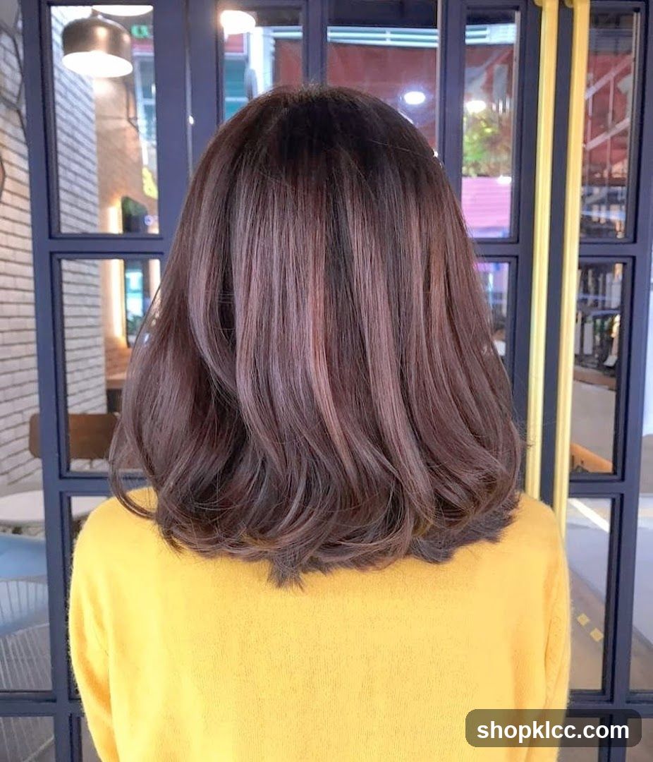 Back view of person with shoulder-length hair in yellow sweater