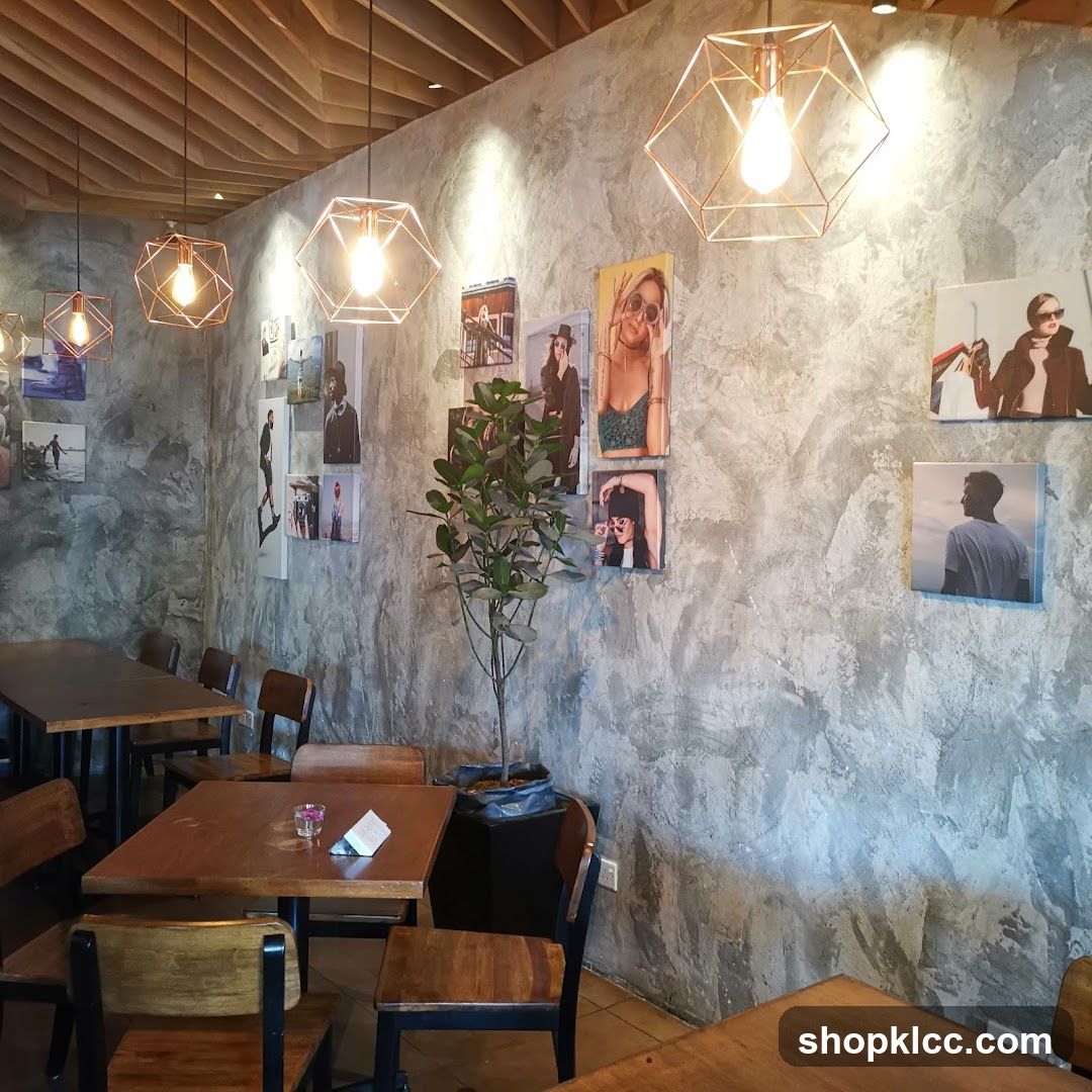 Interior of a cafe with concrete walls and framed photos