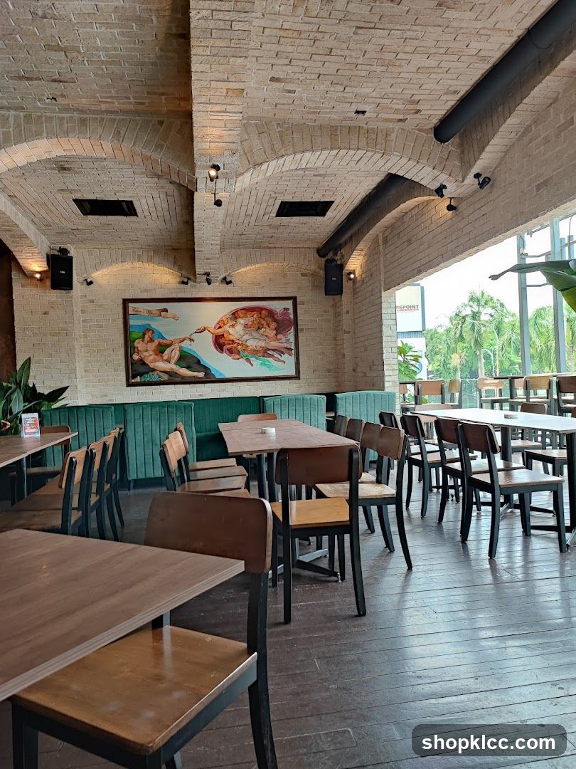 Interior of a restaurant with brick arches and artwork