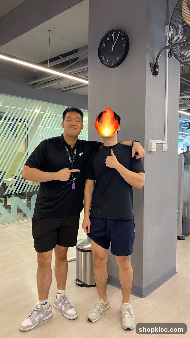 Two men in gym attire posing indoors