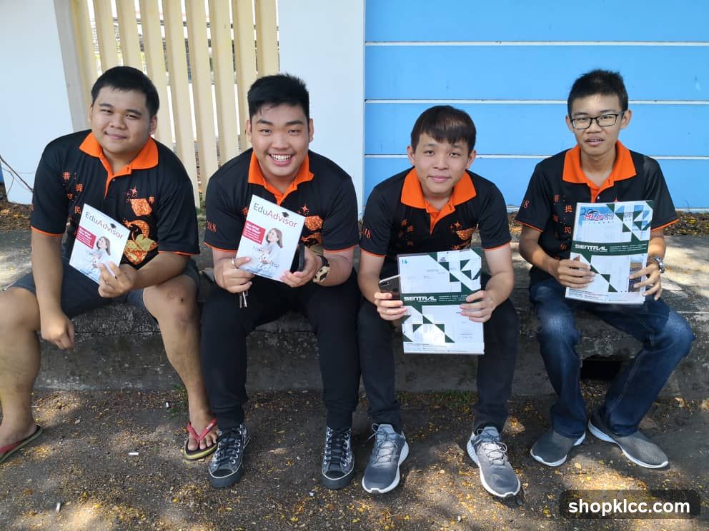Students holding educational brochures