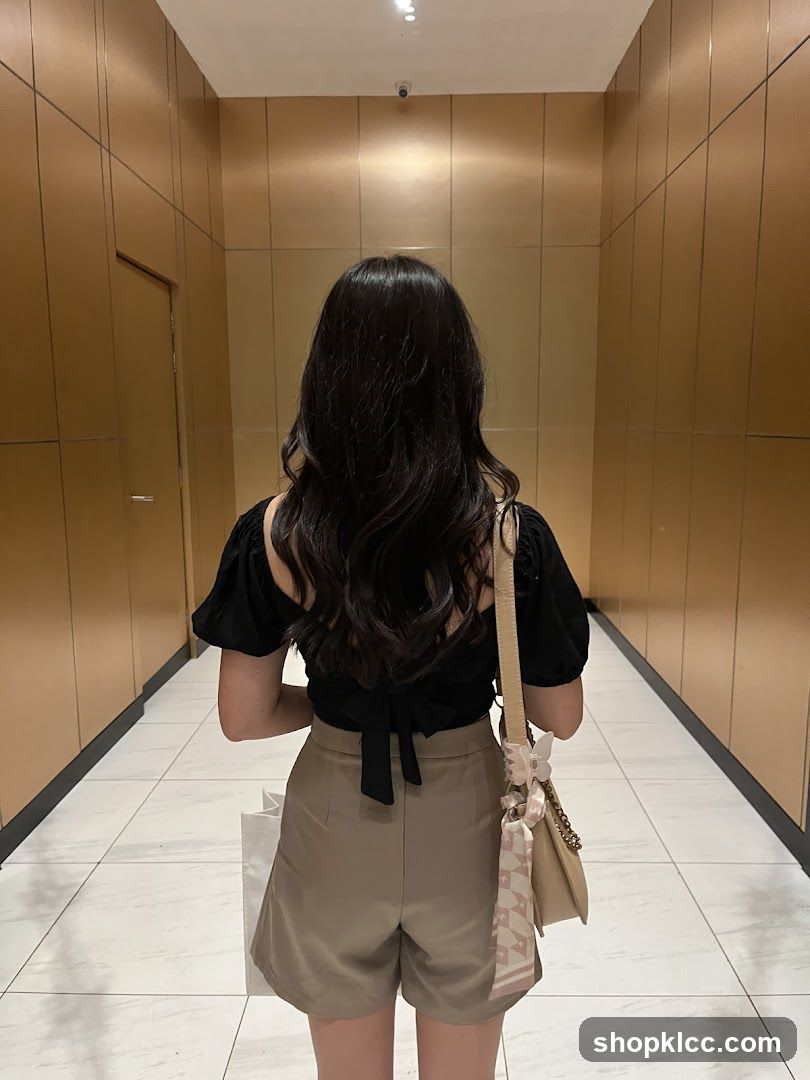 Woman in hallway with bag and shorts
