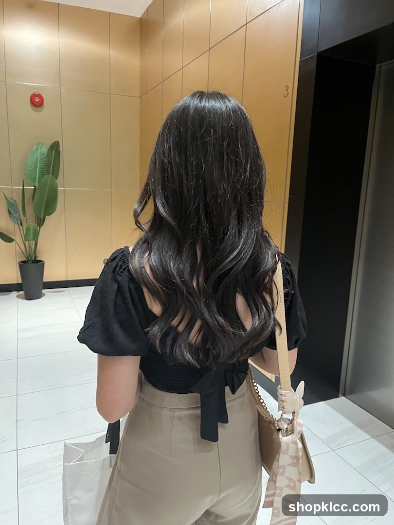 Woman with long wavy hair in hallway