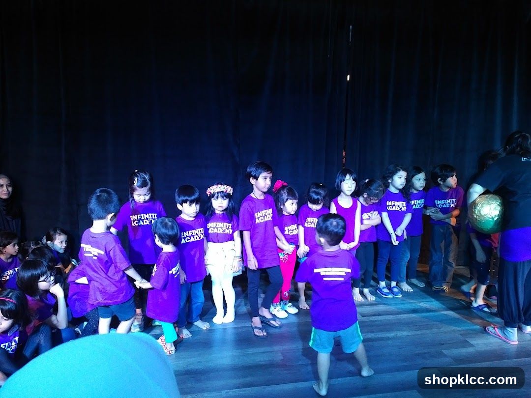 Children in purple shirts on stage