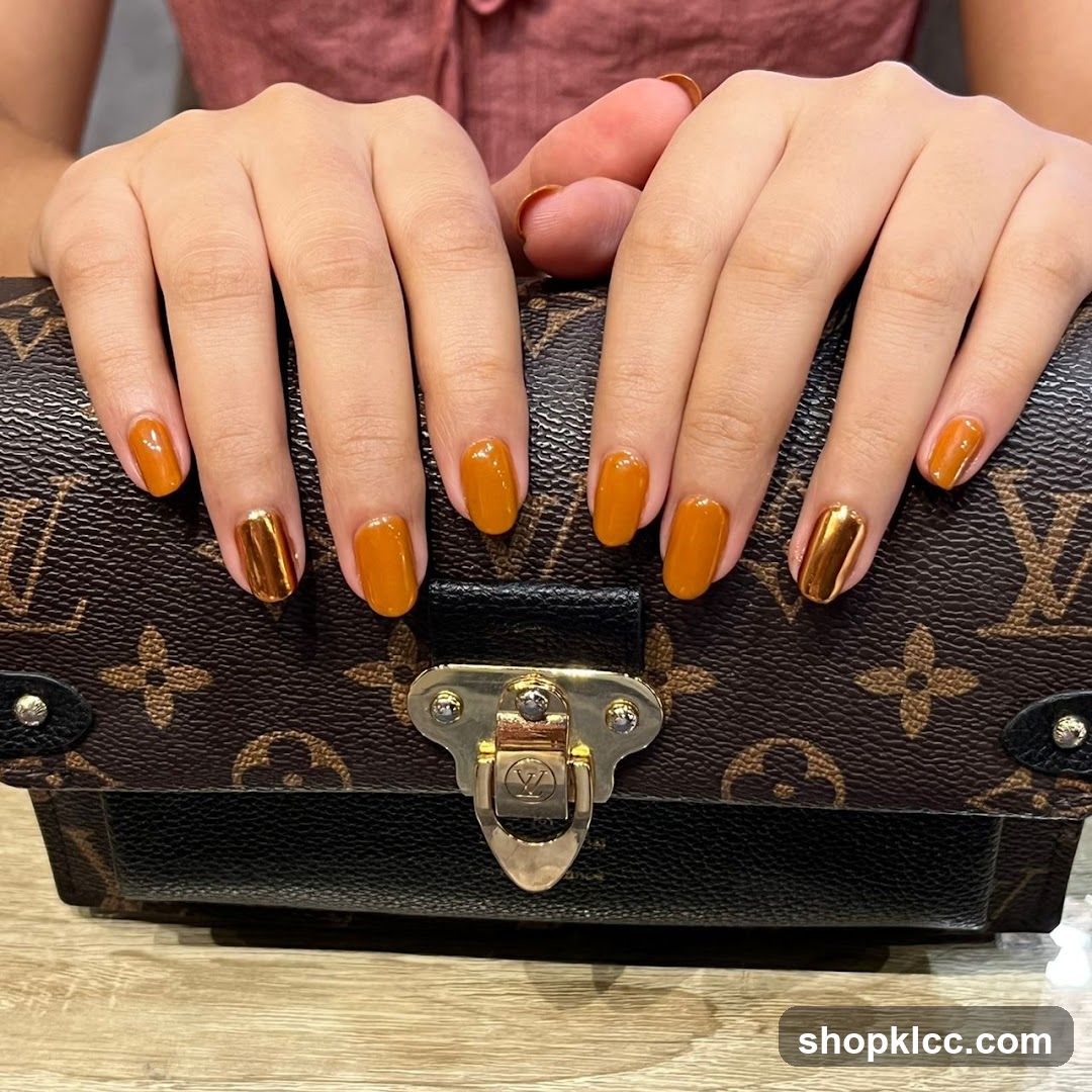 Woman's Hands with Orange and Gold Nails