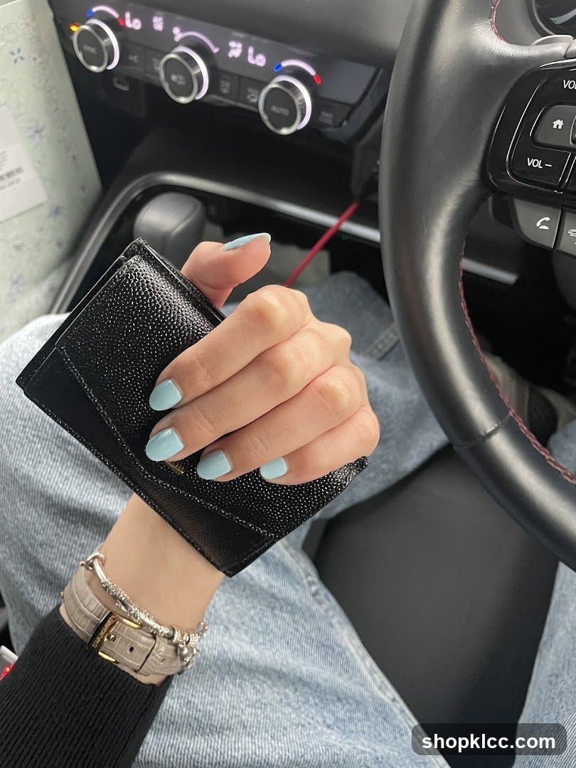 Person holding a wallet in a car