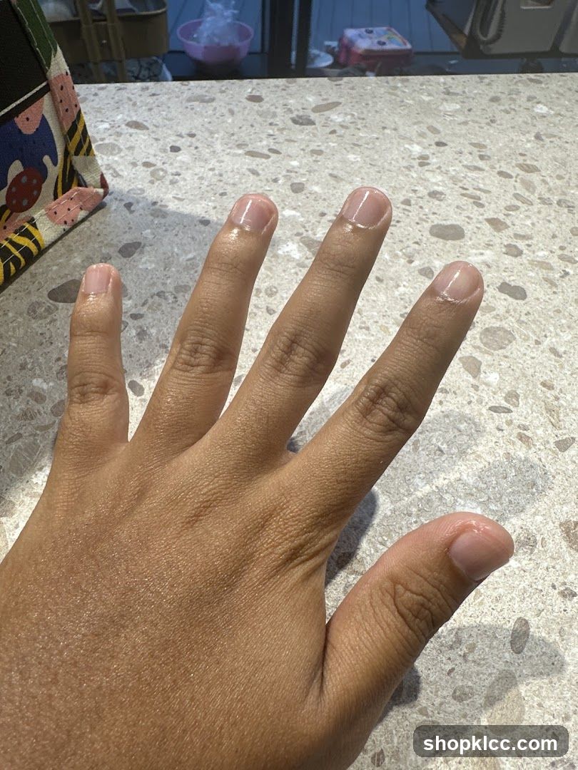 Hand with clear nail polish