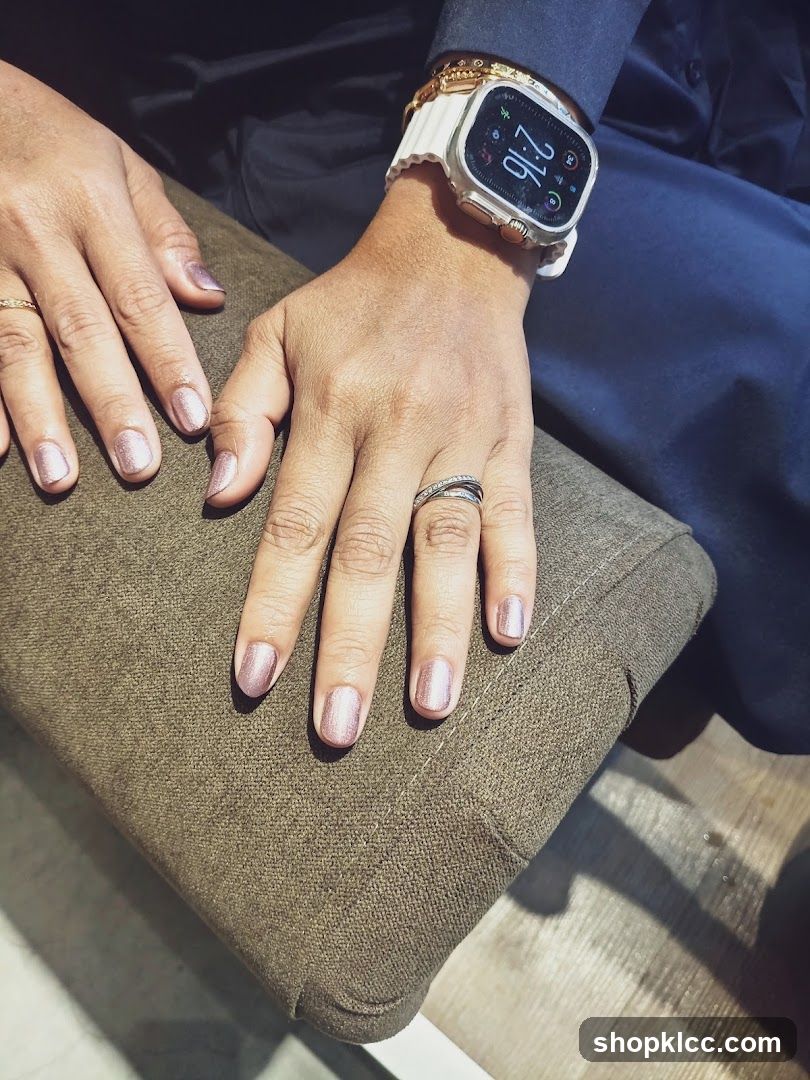 Close-up of hands with manicured nails and a smartwatch