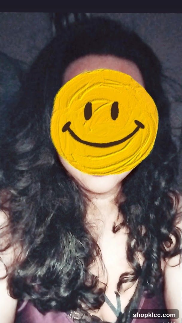 Woman with smiley face covering her face