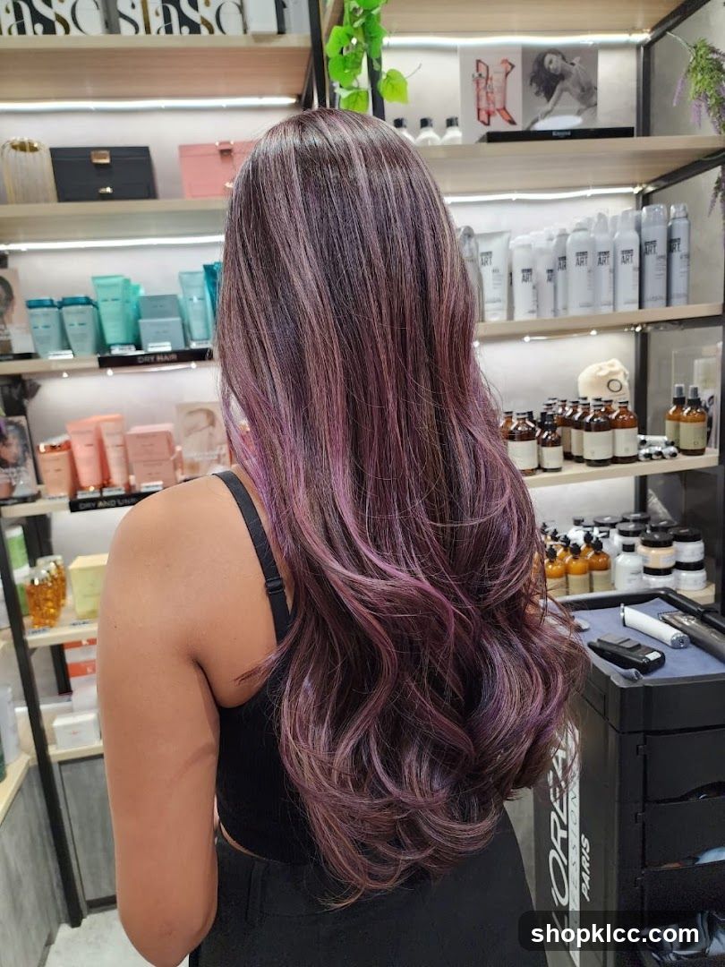 Woman with purple-highlighted hair in a salon