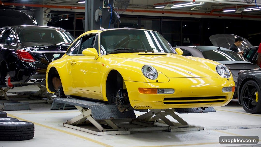 Yellow Porsche on Lift in Garage