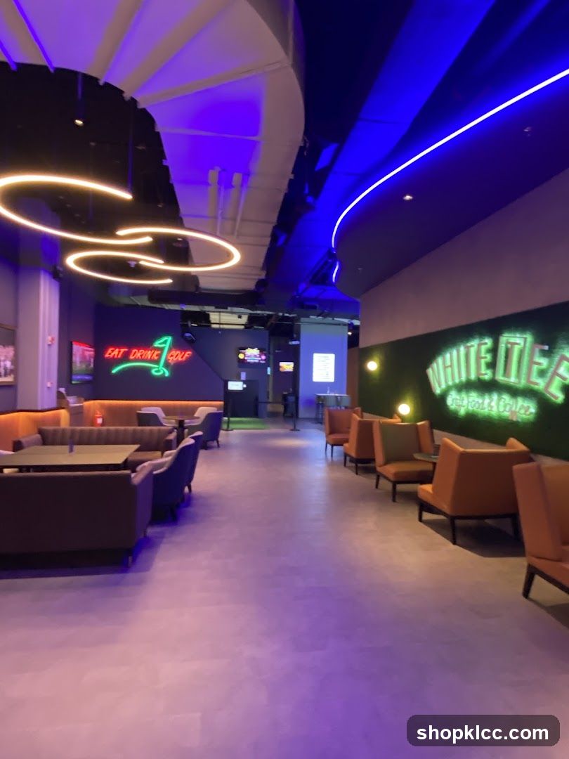 Indoor entertainment venue with seating and neon signs