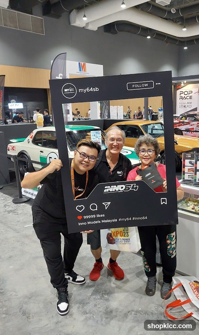 People posing with a large Instagram frame