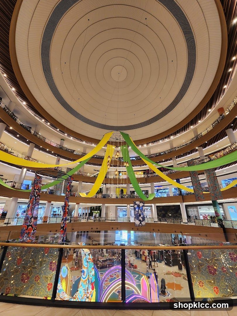 Interior of a multi-level shopping mall with decorative streamers and lights.