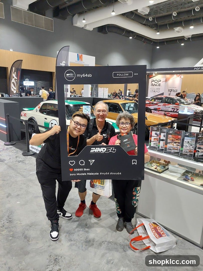 People posing with a photo frame at an event