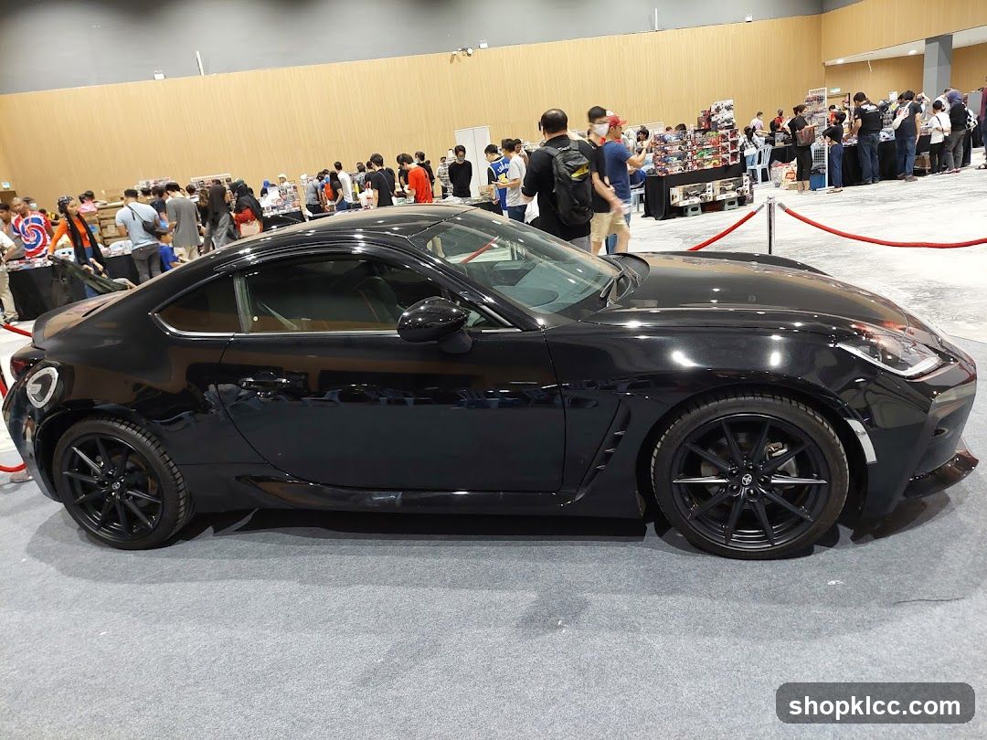 Black sports car on display at an event