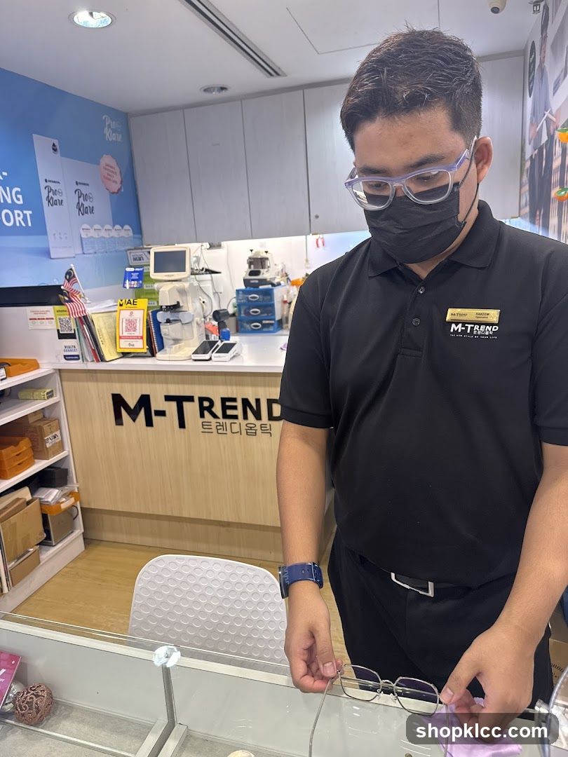 Optician assisting customer