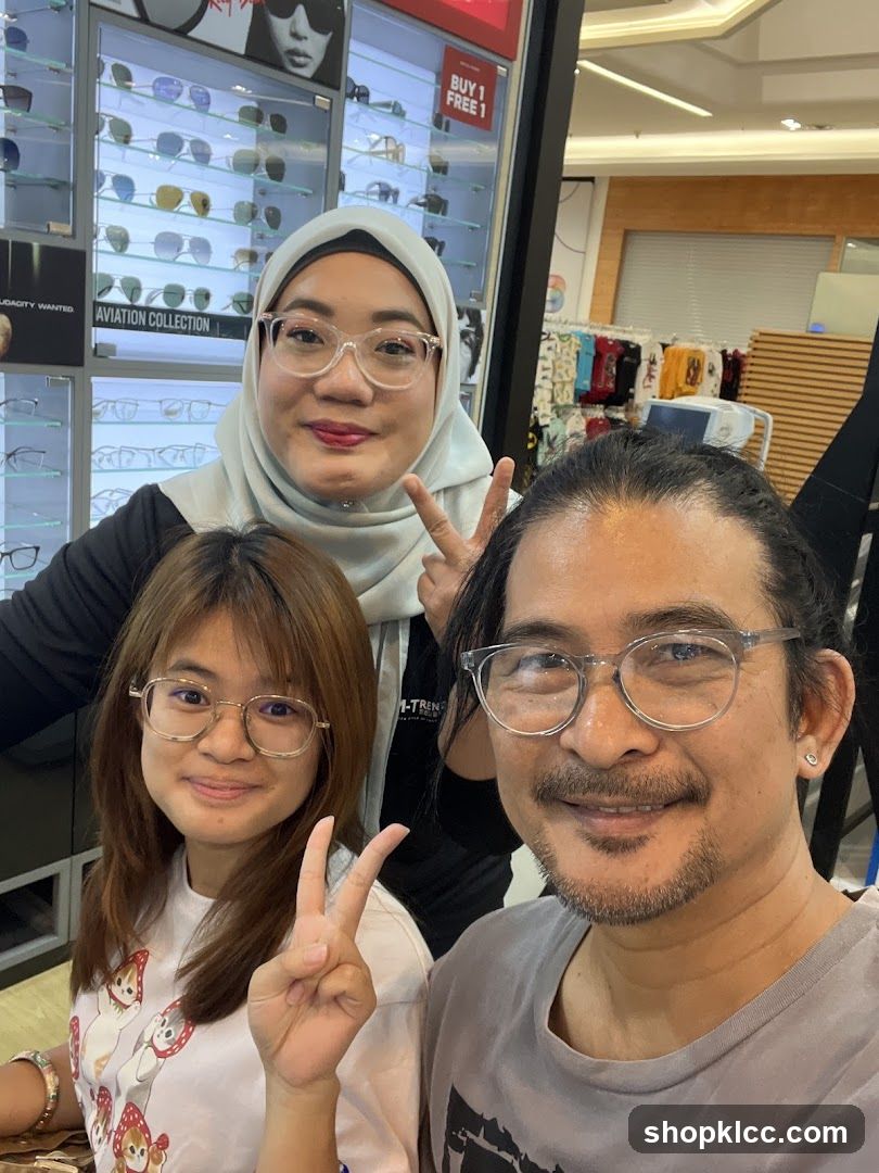 Three people posing for a photo in an optical shop