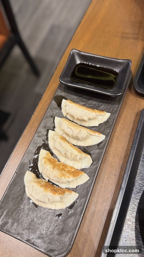 Pan-fried dumplings with dipping sauce