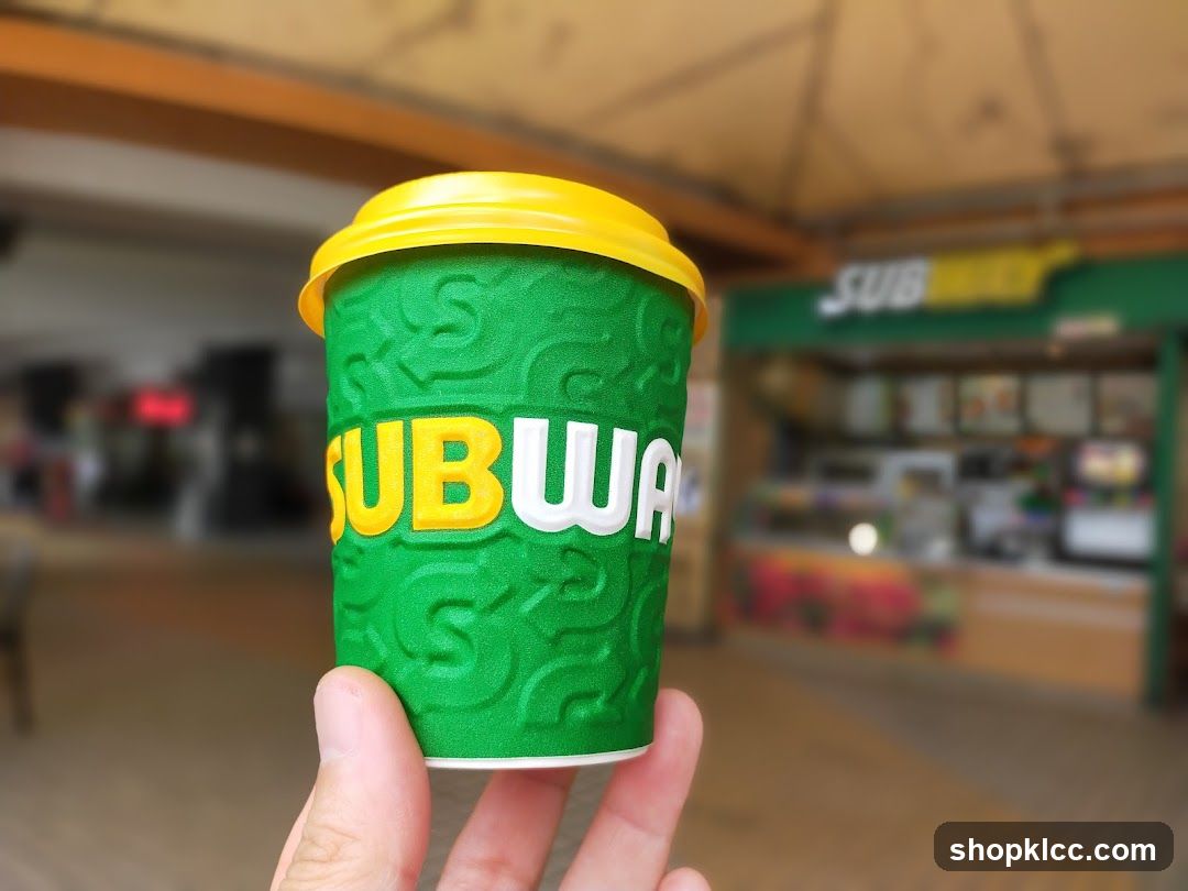 Subway cup in front of a Subway store