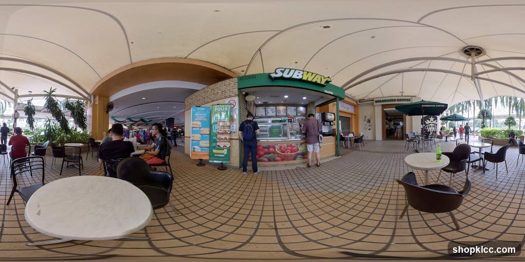 Outdoor seating area with Subway and Starbucks