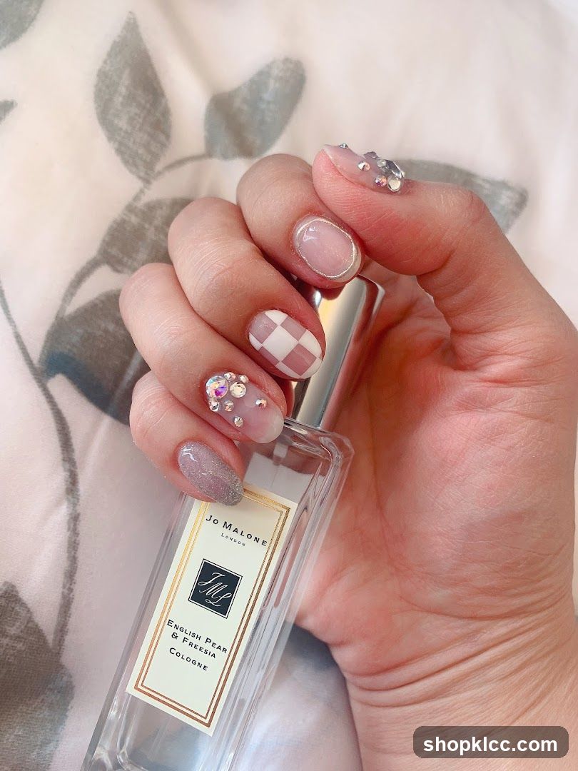 Hand holding Jo Malone perfume bottle