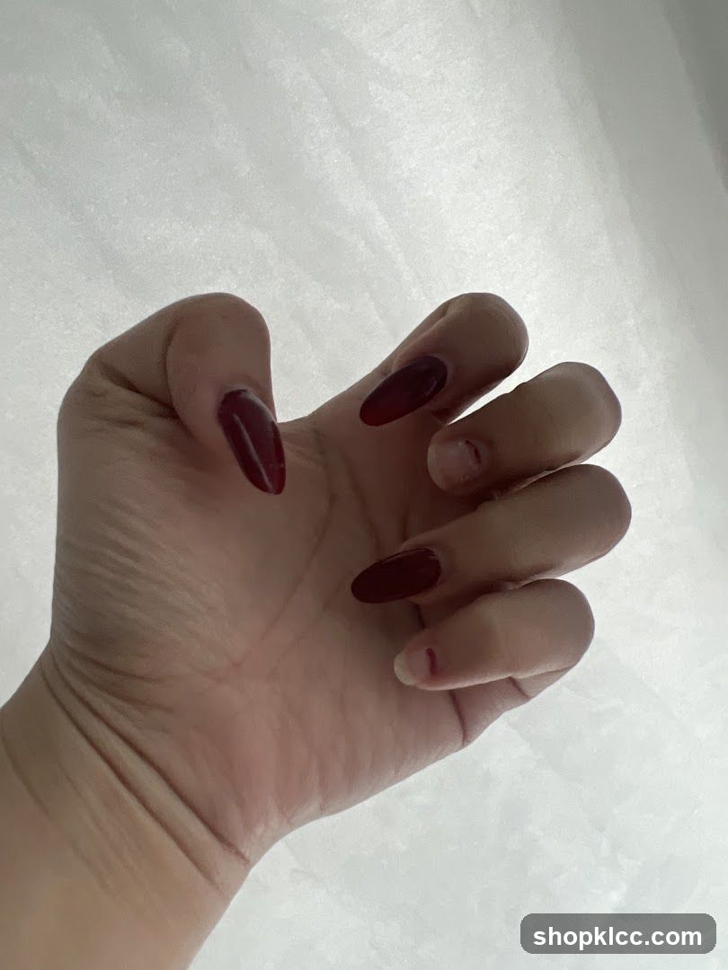 Hand with dark red nails