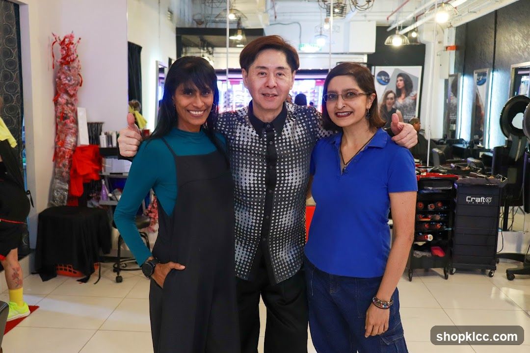 Three people posing in a salon