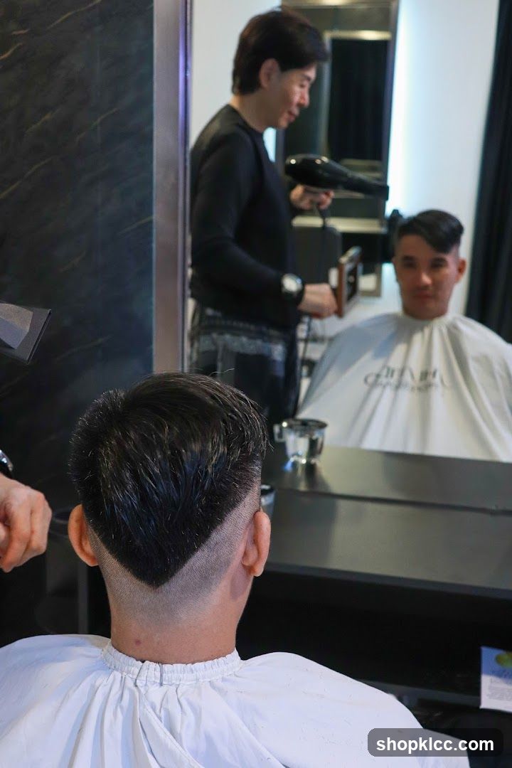 Hairdresser drying client's hair