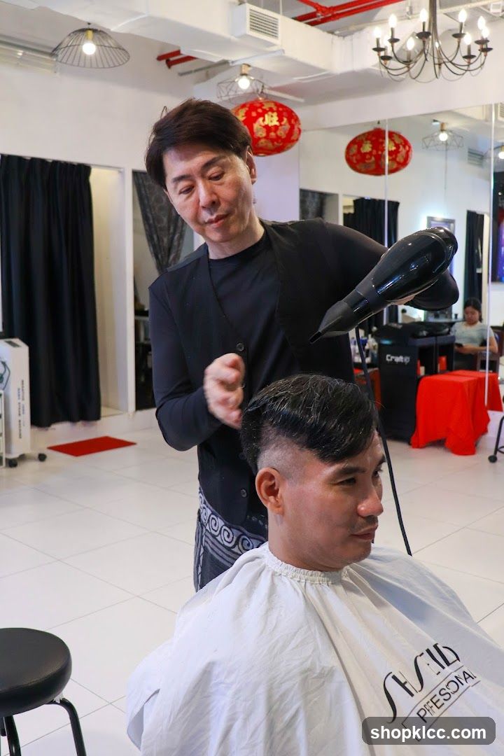Hairdresser drying client's hair