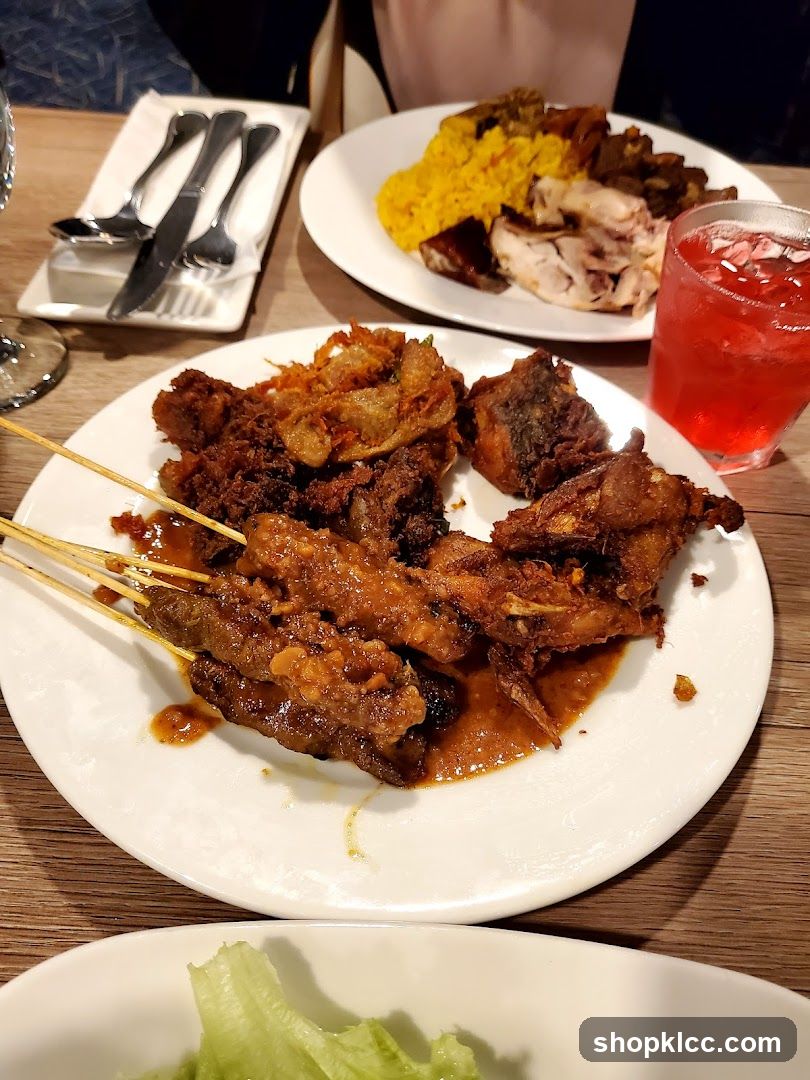 Plates of food with satay and rice