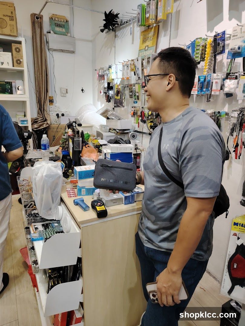 Man holding a pouch in a store