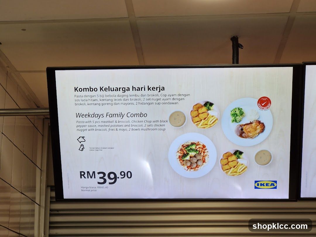A digital menu board displaying a family combo meal with descriptions in Malay and English. The combo includes pasta with meatballs and broccoli, chicken chop with black pepper sauce, mashed potatoes and broccoli, chicken nuggets with fries and mayo, and mushroom soup.