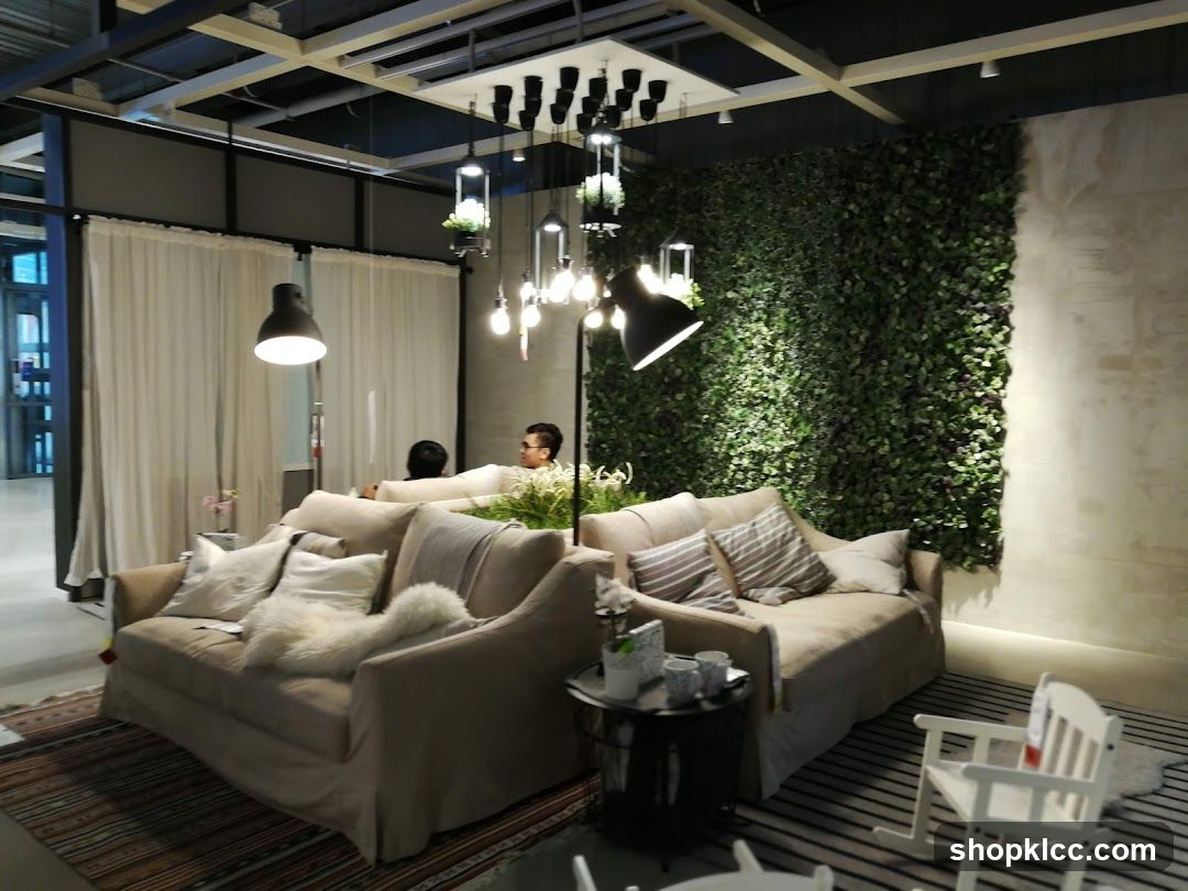 Living room display with sofas and greenery