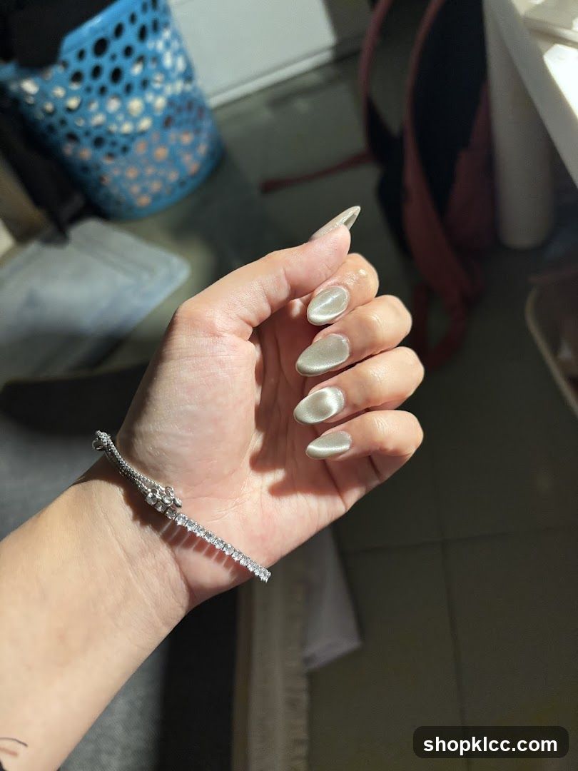 Woman's Hand with Cat Eye Nails and Diamond Bracelet