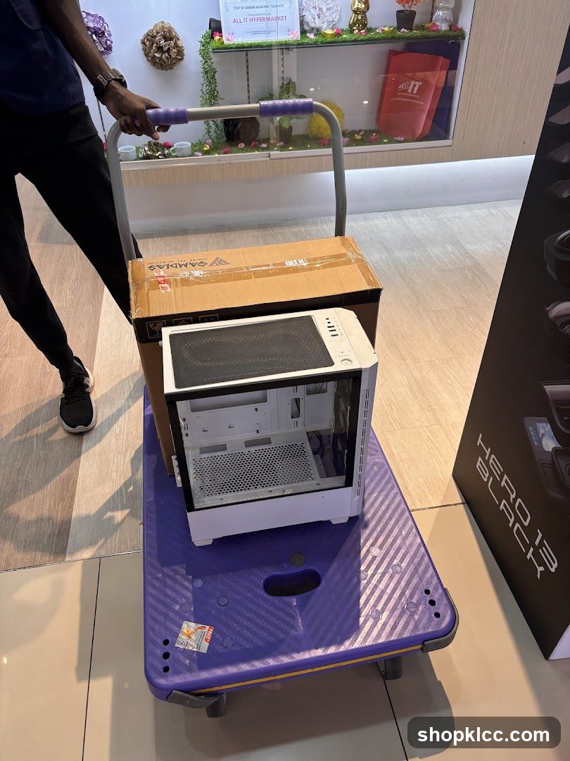 Person pushing a cart with computer parts