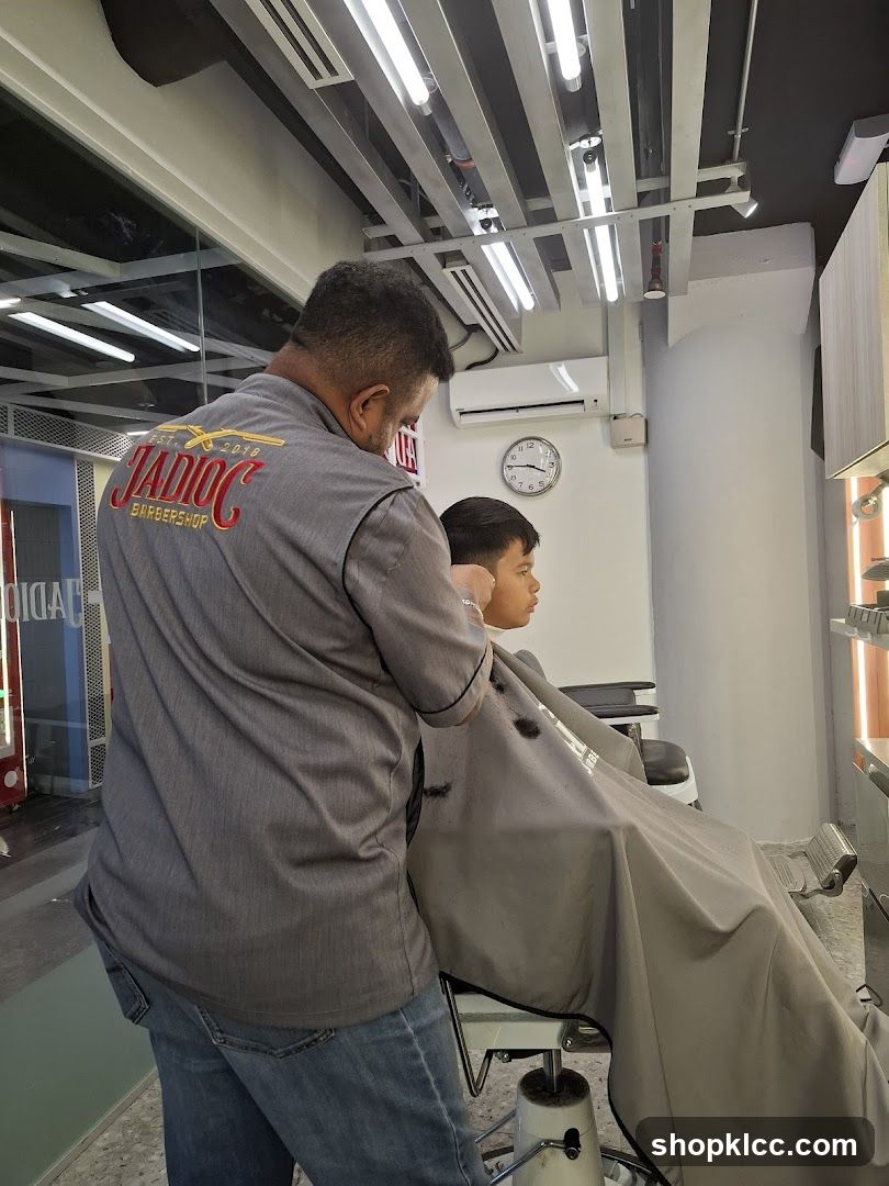 Barber cutting a boy's hair