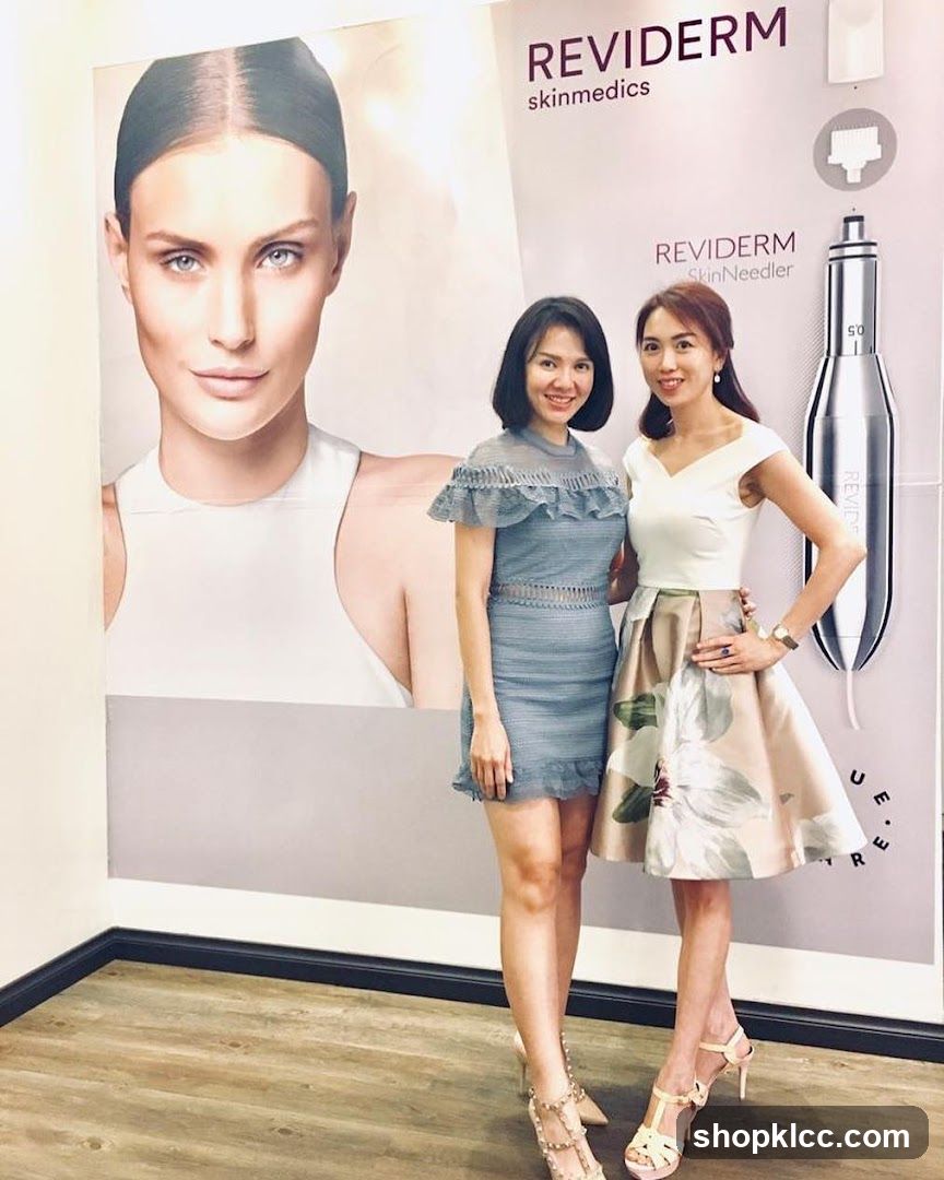 Two Women Posing in Front of a Large Advertisement