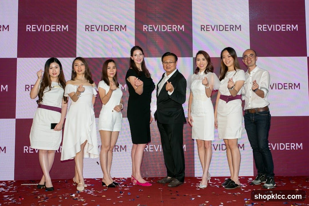 Group Posing with REVIDERM Branding
