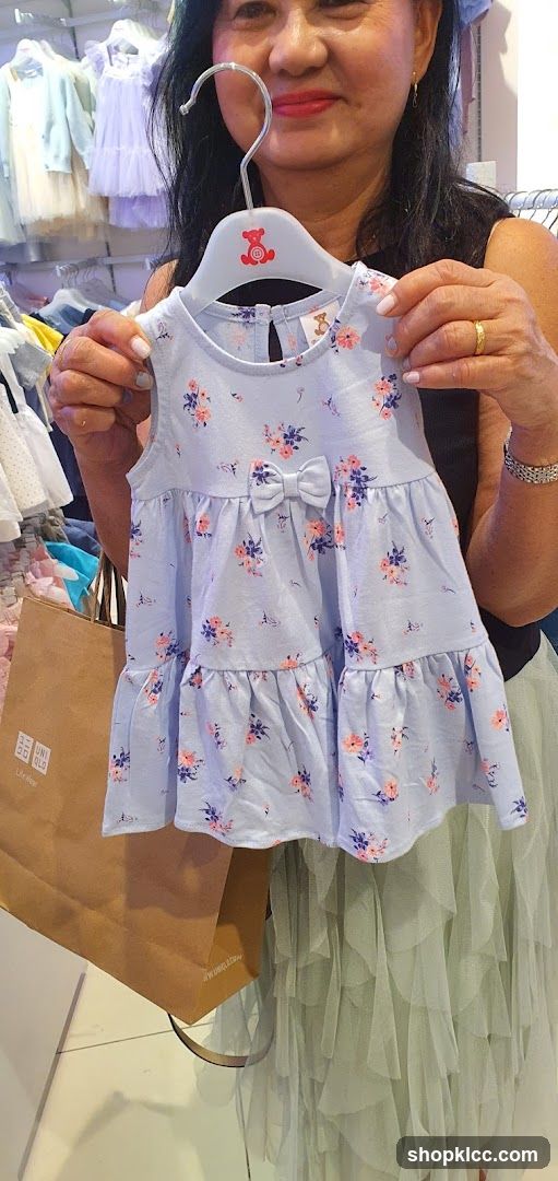 Woman holding a baby dress
