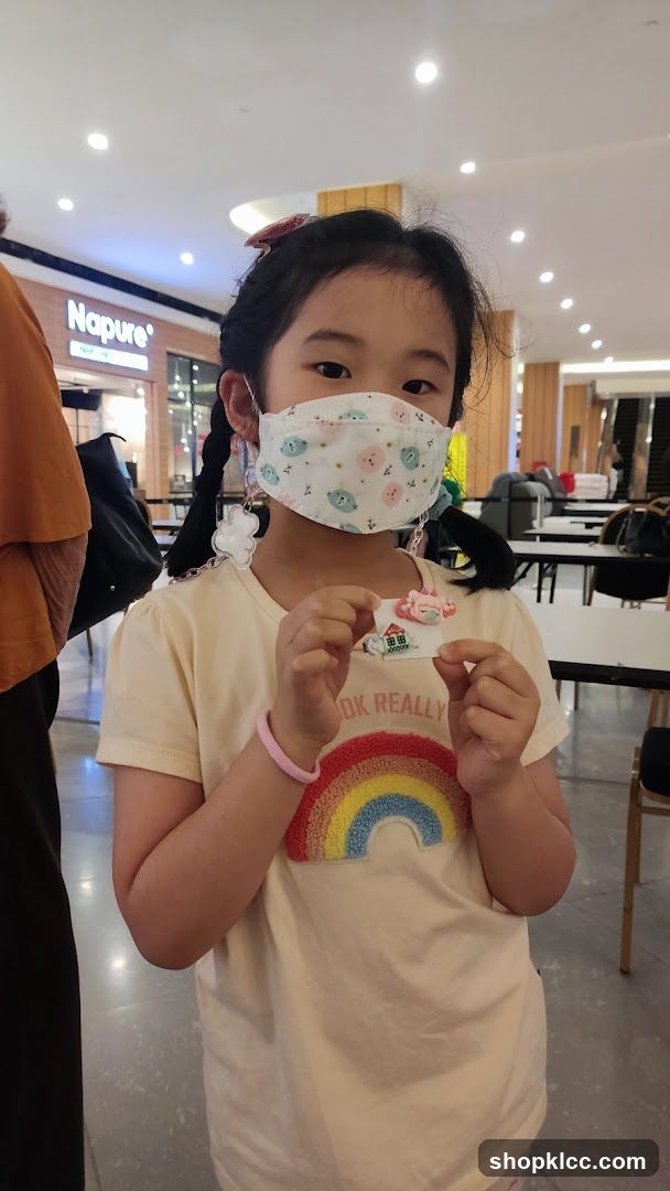 Girl with mask and rainbow shirt