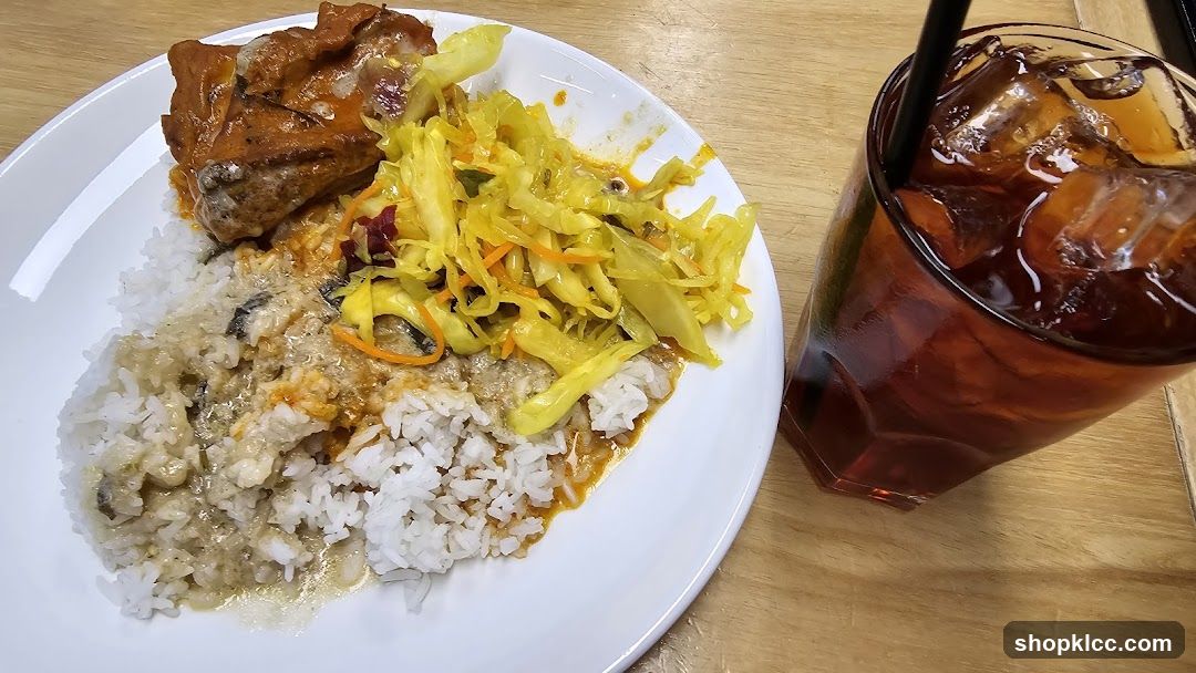 Plate of food with rice, meat, and side salad