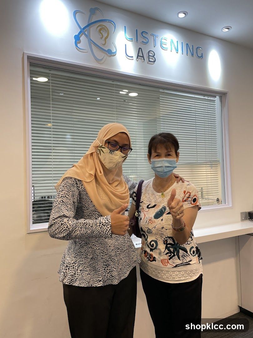 Two women posing in front of Listening Lab