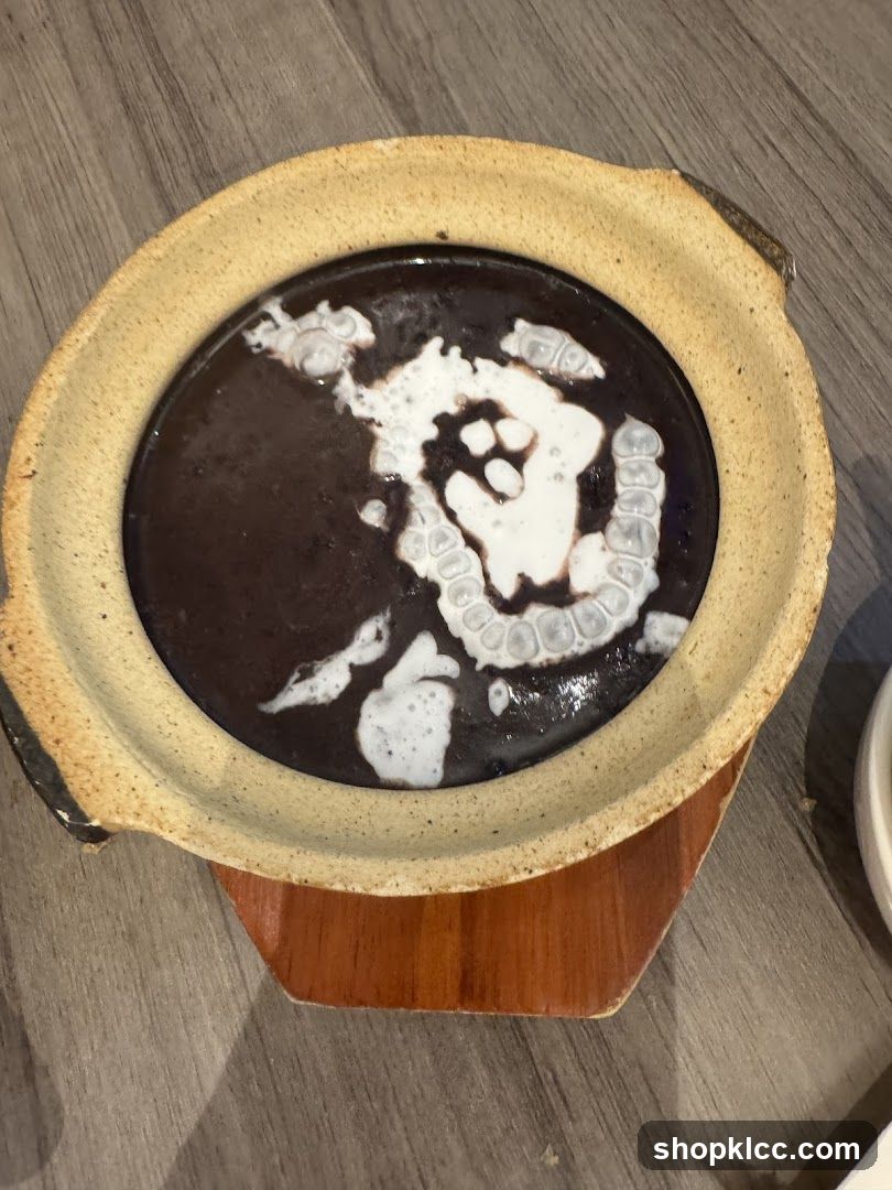 Bowl of Dark Soup with Creamy Topping