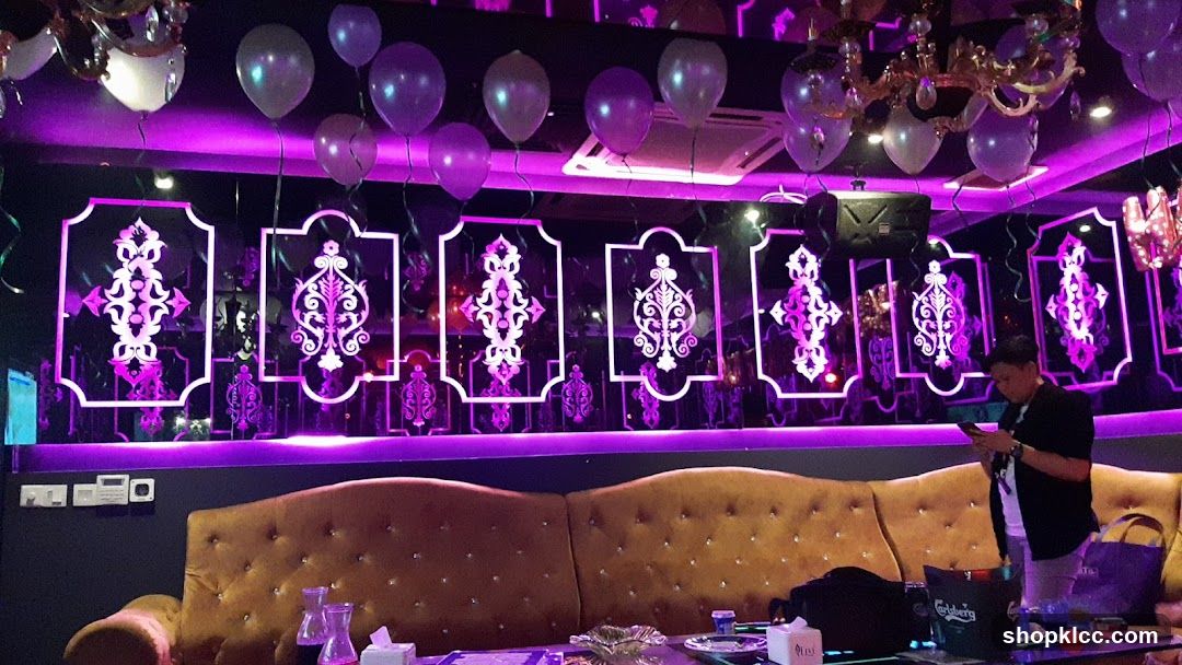 Purple-lit lounge interior with decorative wall panels and balloons