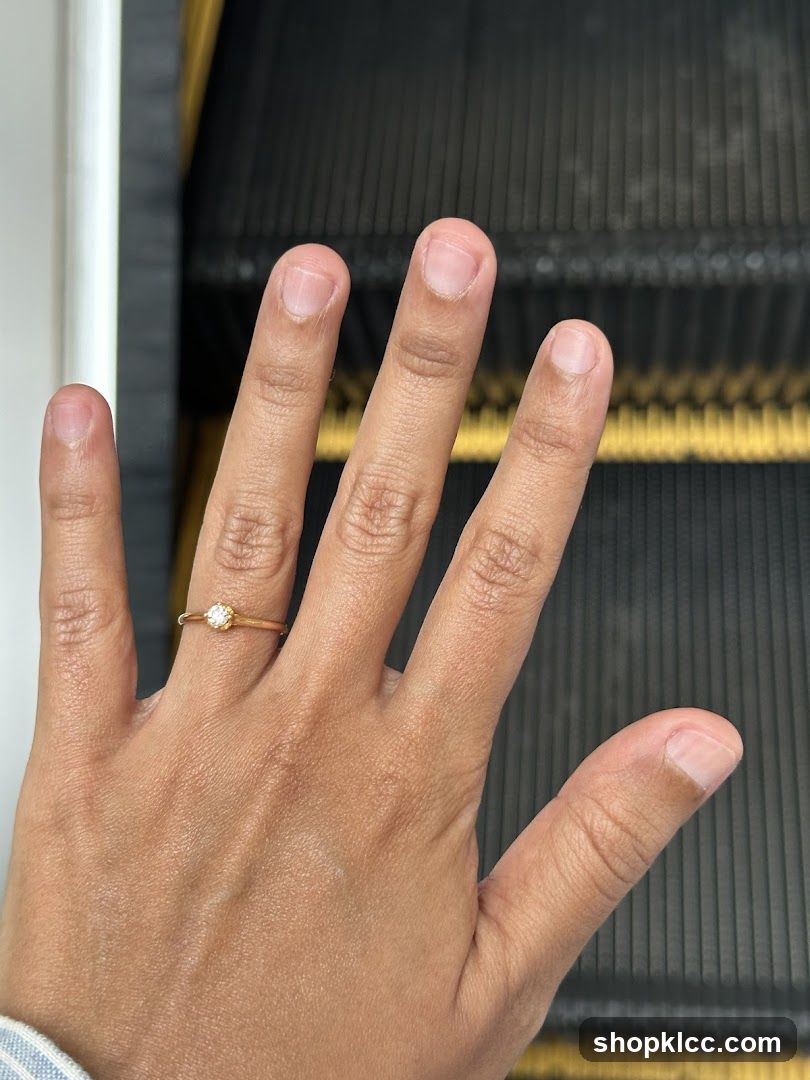 Hand with Ring on Escalator