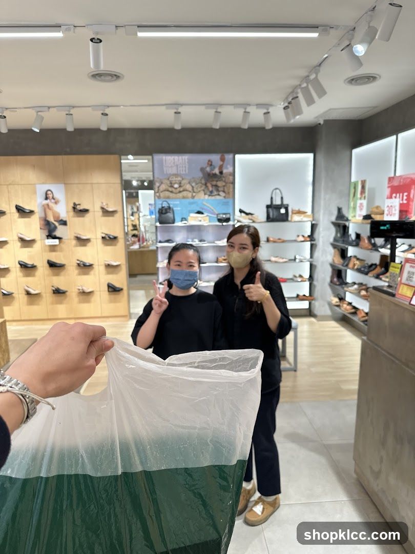 Shoe Store Interior with Staff and Shopping Bag