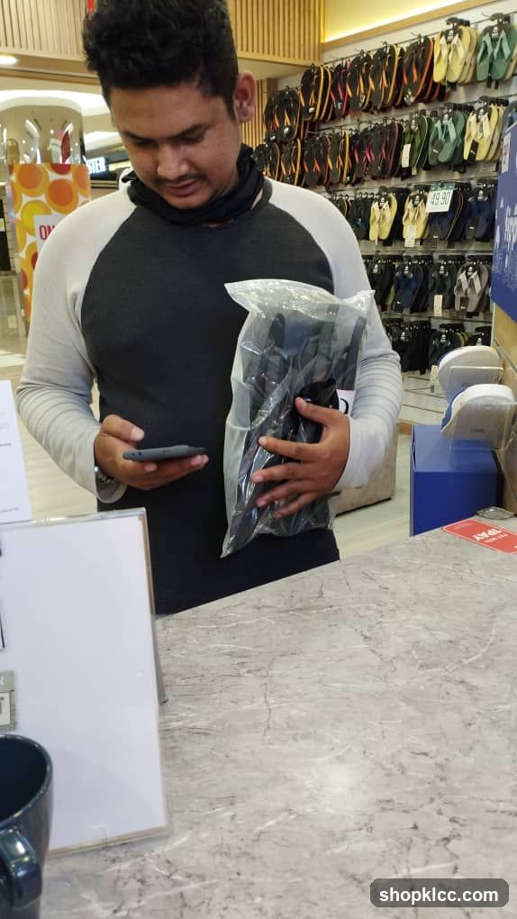 Customer in Store Holding Product