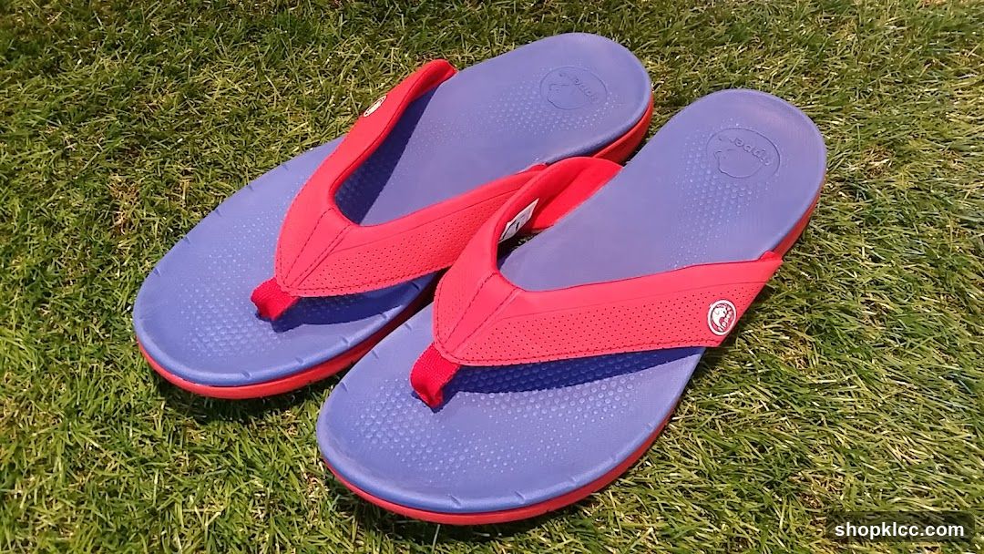 Red and Blue Flip Flops on Grass