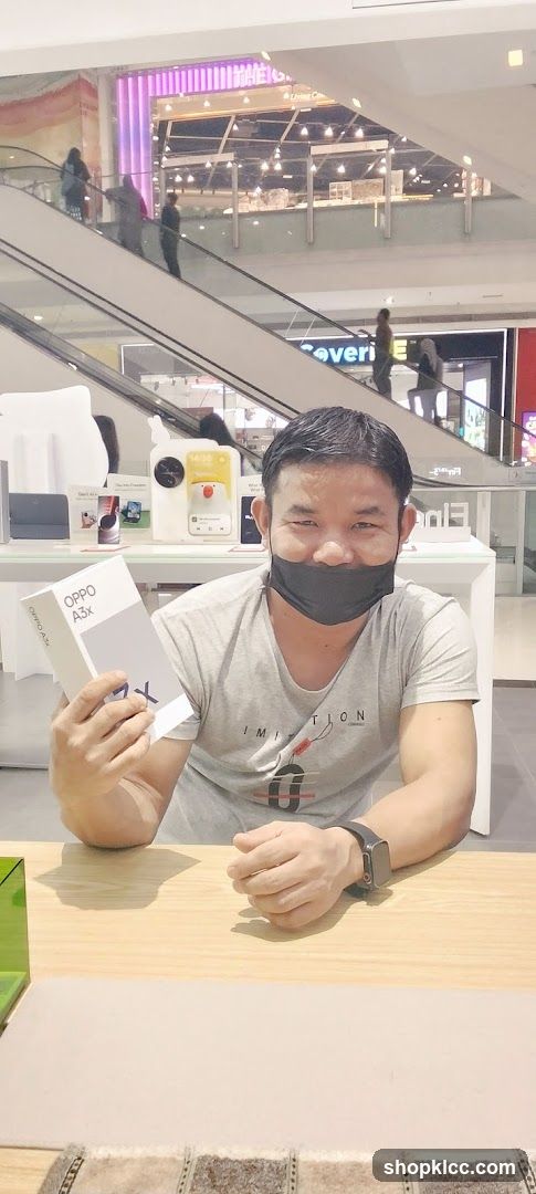 Man holding an Oppo A3x box